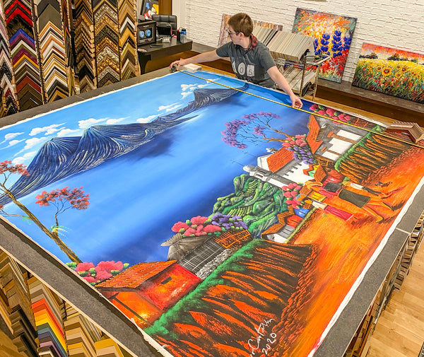 Oversized canvas being measured for framing