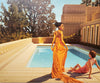 Carrie Graber's original painting of two ladies by a pool and outside a Grecian looking home.
